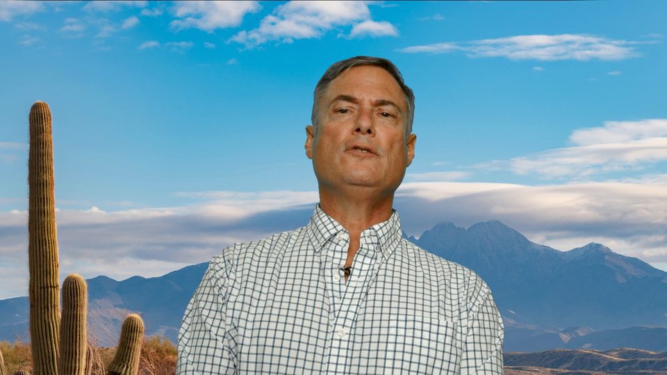Todd Balash in front of a desert landscape