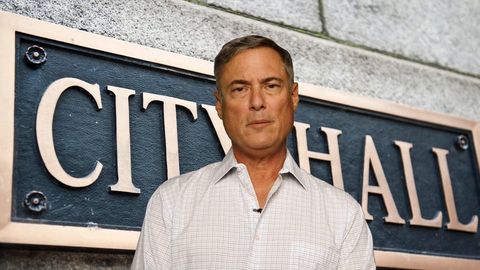 Todd Balash in front of the City Hall sign